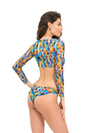 Discover tan-through smart swimsuits featuring a stylish feather print in this file. Our swim top with sleeves ensures quick drying, as showcased at NYFW. Shop now for cutting-edge beachwear!