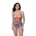 Full-body shot of a model in a Portofino Collection sleeveless one-piece swimsuit, featuring a stylish coastal print with blue and coral hues, standing on a white background.